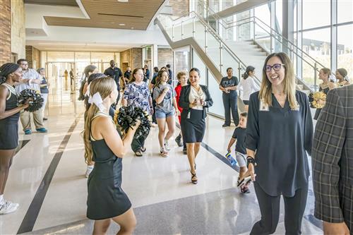 A large crowd walks in the foyer of an auditorium